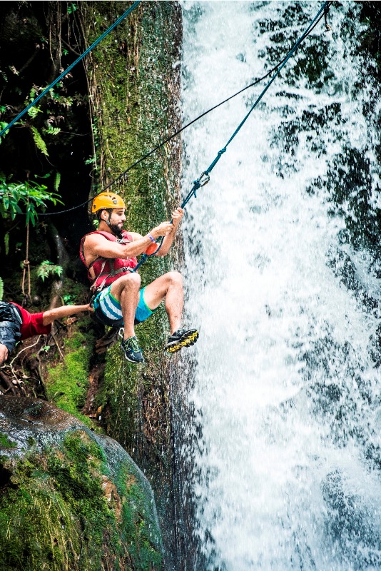 Adventure tour waterfall canyoning at Hacienda Guachipelin