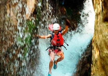 Adventure tour waterfall canyoning at Hacienda Guachipelin